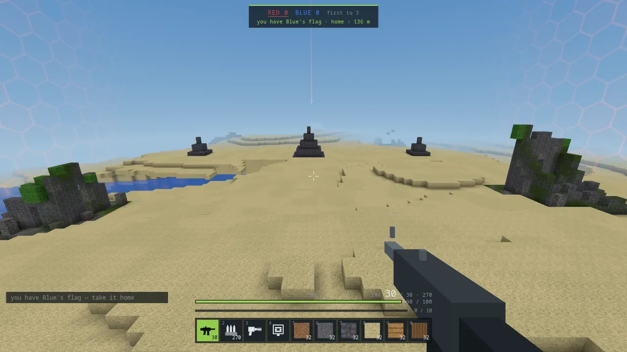 Standing on top of the blue team's bedrock pyramid, looking back across a desert map, with the readout saying you have Blue's flag, home 136 metres away